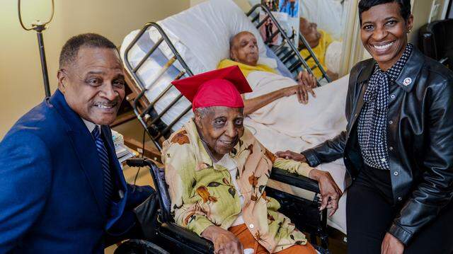 Clark Atlanta University president Dr. George T. French (left), with Eleanor Gittens, Lyle Gittens (in the bed) and Clark Atlanta University vice president Lorri L. Saddler. The couple was honored by their alma mater for their enduring love and for Eleanor’s 85 years as an alum. 